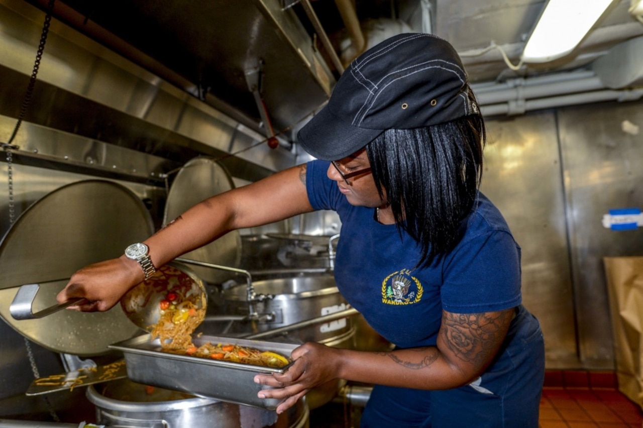 Navy cook prepares a meal.