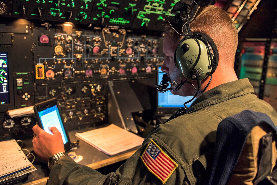 An airman checks flight instruments on a C-5M Super Galaxy.
