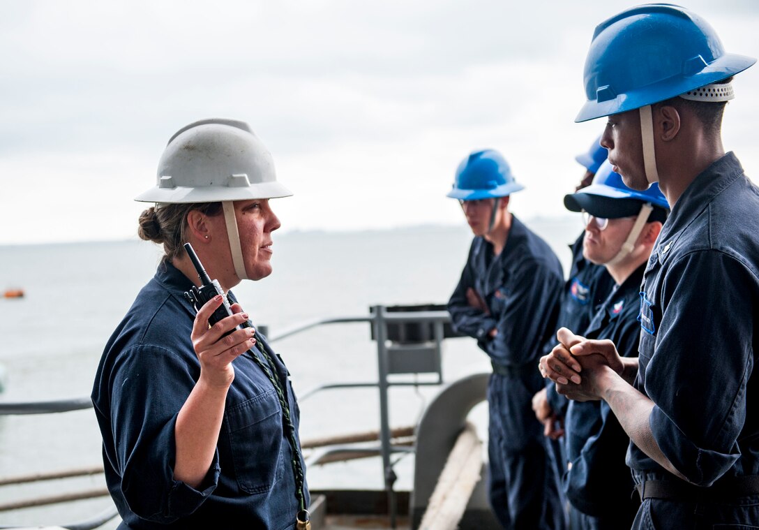 Supervisor briefs sailors on anchor detail.