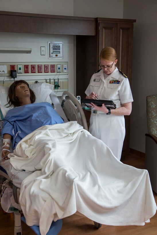 Navy Lt. Cmdr. Eileen Scott, department head of the Mother Infant Care Center at Robert M. Casey Naval Family Branch Clinic Iwakuni, demonstrates the capabilities of an advanced simulation manikin at Marine Corps Air Station Iwakuni, Japan, May 30, 2018. The demonstration was part of the grand opening of the Robert M. Casey Naval Family Branch Clinic Iwakuni. The staff hosted the grand opening in order to display the facility’s new and improved capabilities.