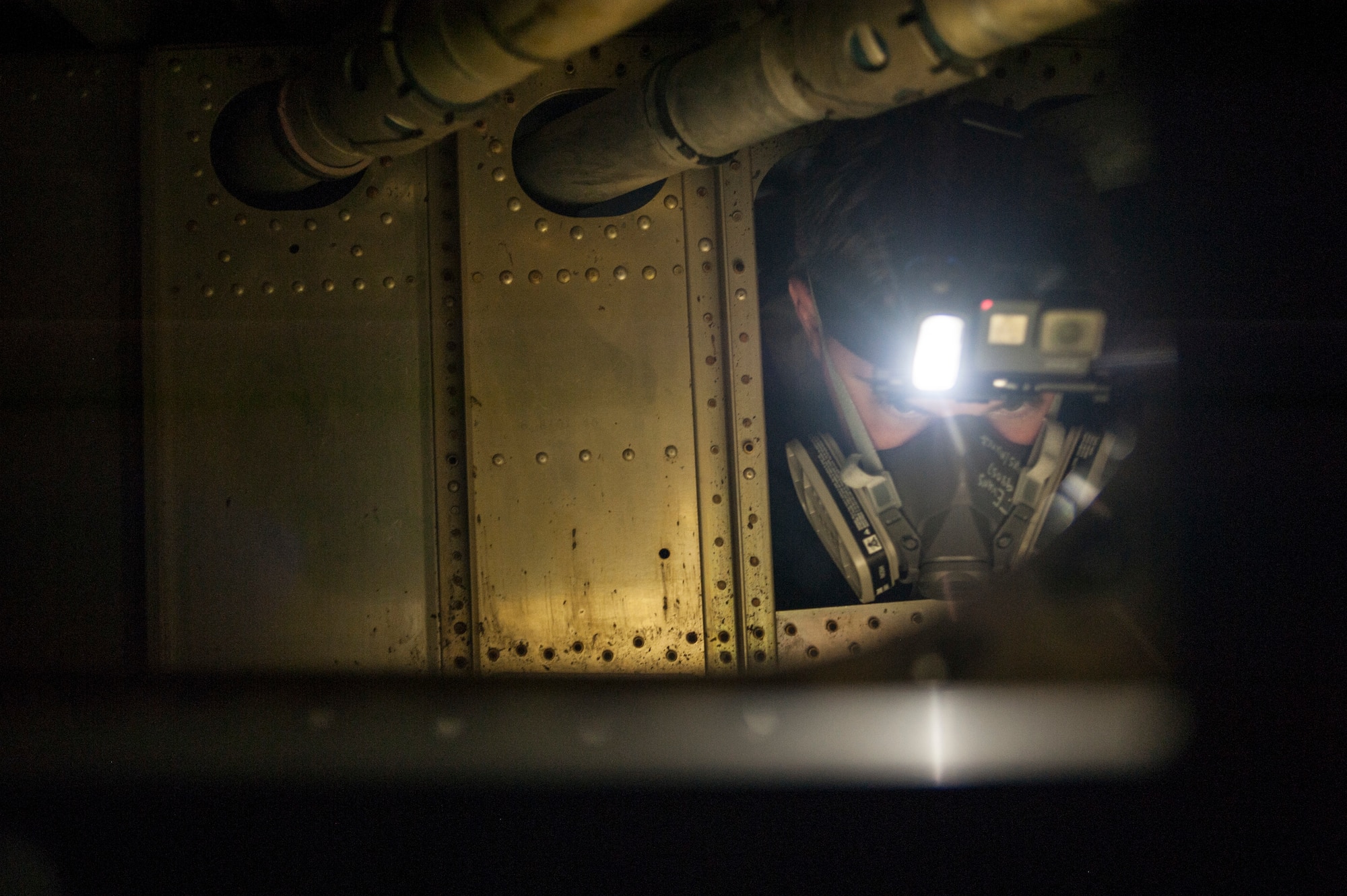 U.S. Air Force Senior Airman Triston Evans, an aircraft fuel systems journeyman assigned to the 6th Maintenance Squadron, squeezes through the interworking of a KC-135 Stratotanker training fuel cell at MacDill Air Force Base, Fla., May 30, 2018.