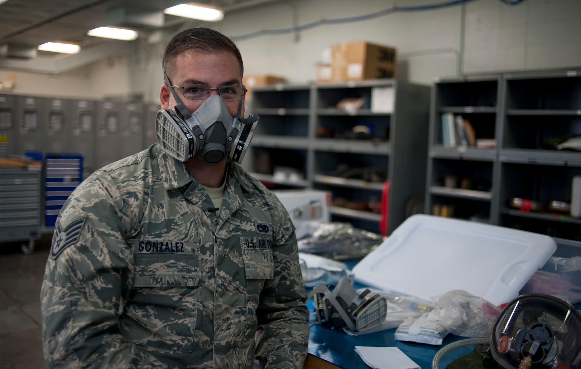 U.S. Air Force Staff Sgt. Adrian Gonzalez, an aircraft fuel systems craftsman with the 6th Maintenance Squadron, demonstrates how to wear a respirator at MacDill Air Force Base, Fla., May 30, 2018.