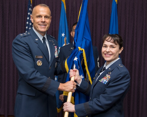 Brig. Gen. Alice W. Treviño accepts the Air Force Installation Contracting Agency flag from Maj. Gen. Bradley D. Spacy, Air Force Installation and Mission Support Center commander, as she becomes the AFICA commander May 23, 2018, during a change of command ceremony in the Wright-Patterson Air Force Base, Ohio, Club.