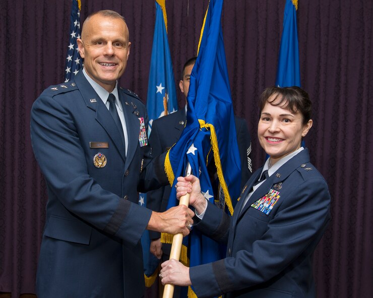 Brig. Gen. Alice W. Treviño accepts the Air Force Installation Contracting Agency flag from Maj. Gen. Bradley D. Spacy, Air Force Installation and Mission Support Center commander, as she becomes the AFICA commander May 23, 2018, during a change of command ceremony in the Wright-Patterson Air Force Base, Ohio, Club.