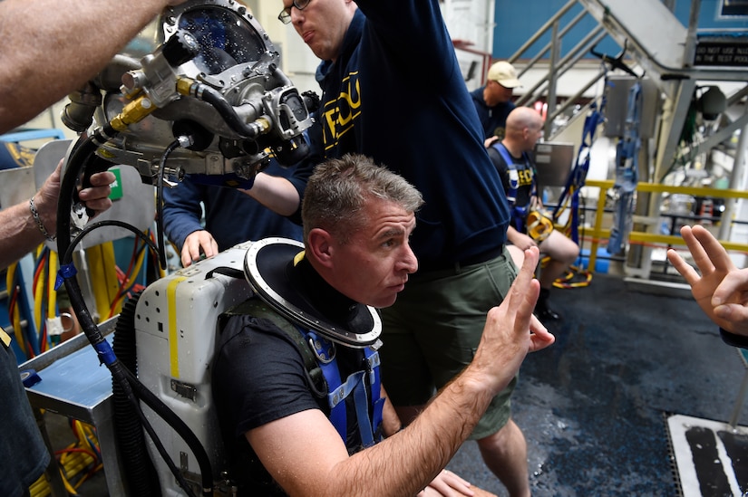 A Navy diver gives the OK sign following his dive using the Office of Naval Research TechSolutions-sponsored MK29 Mixed Gas Rebreather system developed at the Naval Surface Warfare Center Panama City Division, Fla.