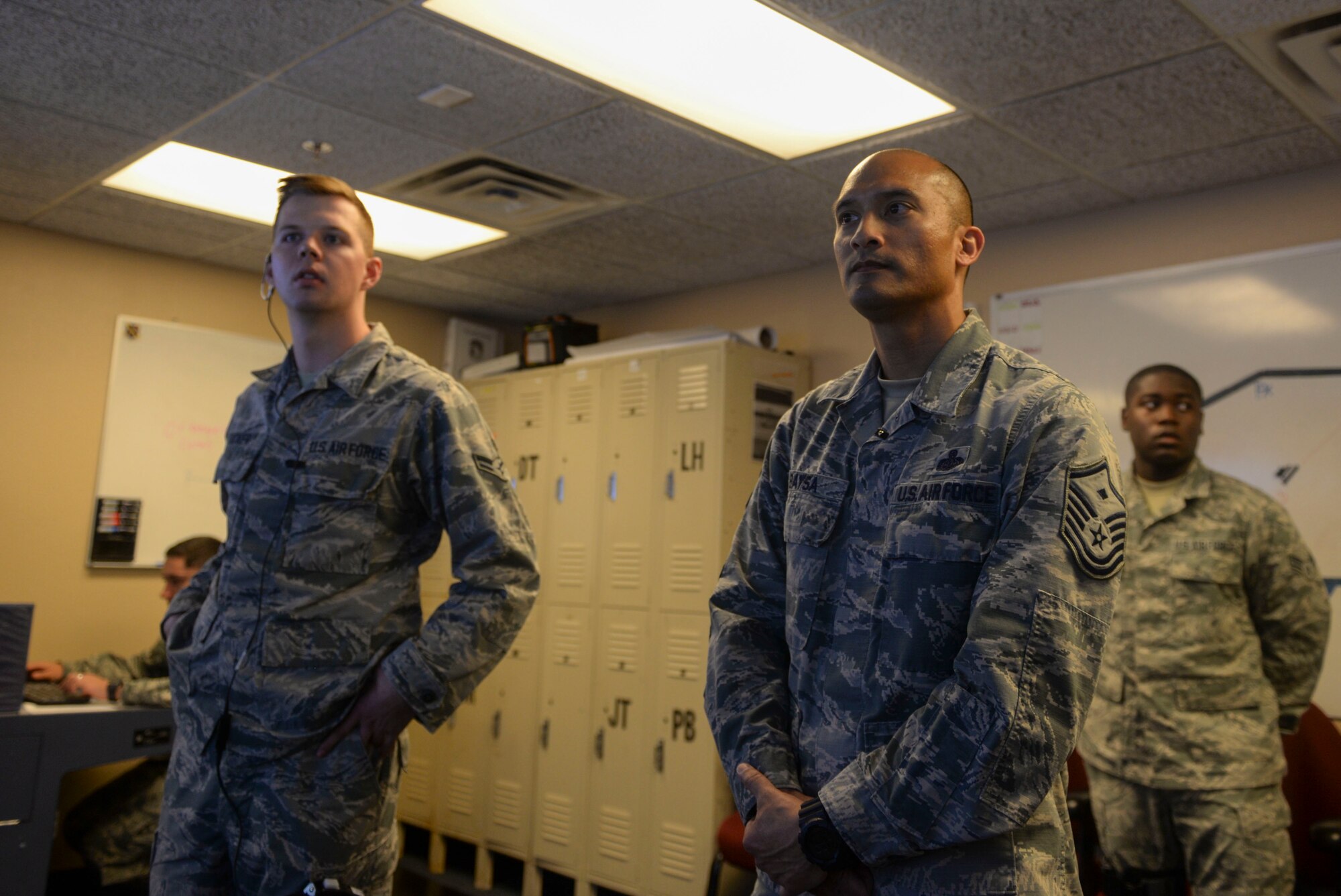 Master Sgt. Jonathan Baysa, 57th Operations Group first sergeant, observes Airmen training in the air traffic control tower on Nellis Air Force Base, Nevada, May 9, 2018. As a first sergeant, Baysa is responsible for making sure his Airmen are mission ready. (U.S. Air Force photo by Airman Bailee A. Darbasie)