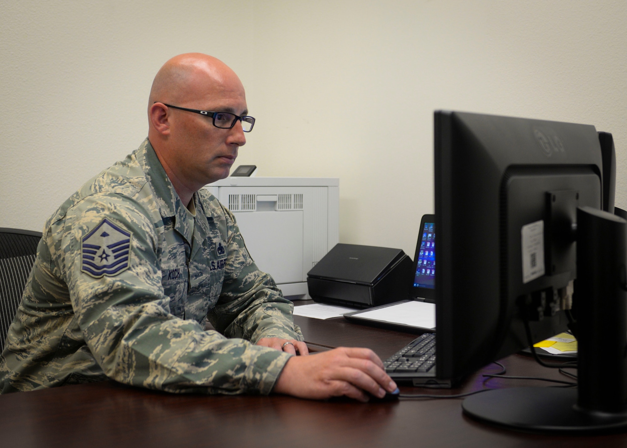 Master Sgt. Justin Koch, 99th Comptroller Squadron first sergeant, checks his email in his office at Nellis Air Force Base, Nevada, May 9, 2018. First shirts can be contacted by calling their first sergeant phone, emailing them or taking a visit to their offices. (U.S. Air Force photo by Airman Bailee A. Darbasie)