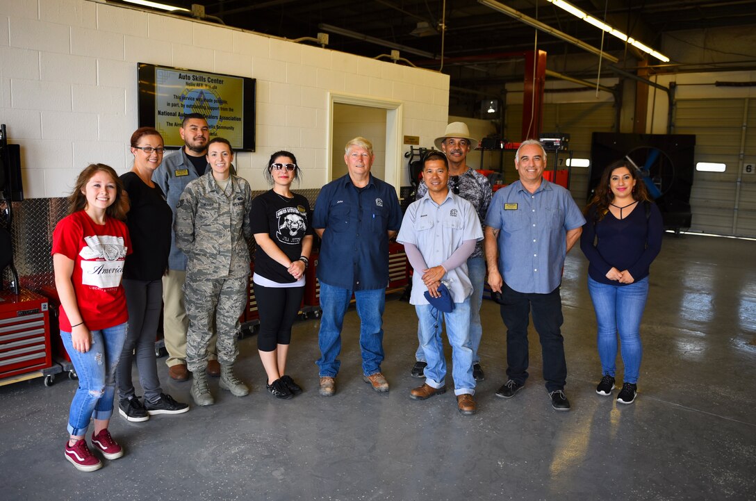Members of the 99th Force Support Squadron celebrate the grand re-opening of the Auto Hobby Shop at Nellis Air Force Base, Nevada, May 31, 2018. The shop underwent major renovations to repair the facility as well as supply customers with the proper tools to perform maintenance on their vehicles. (U.S. Air Force photo by Airman 1st Class Andrew D. Sarver)