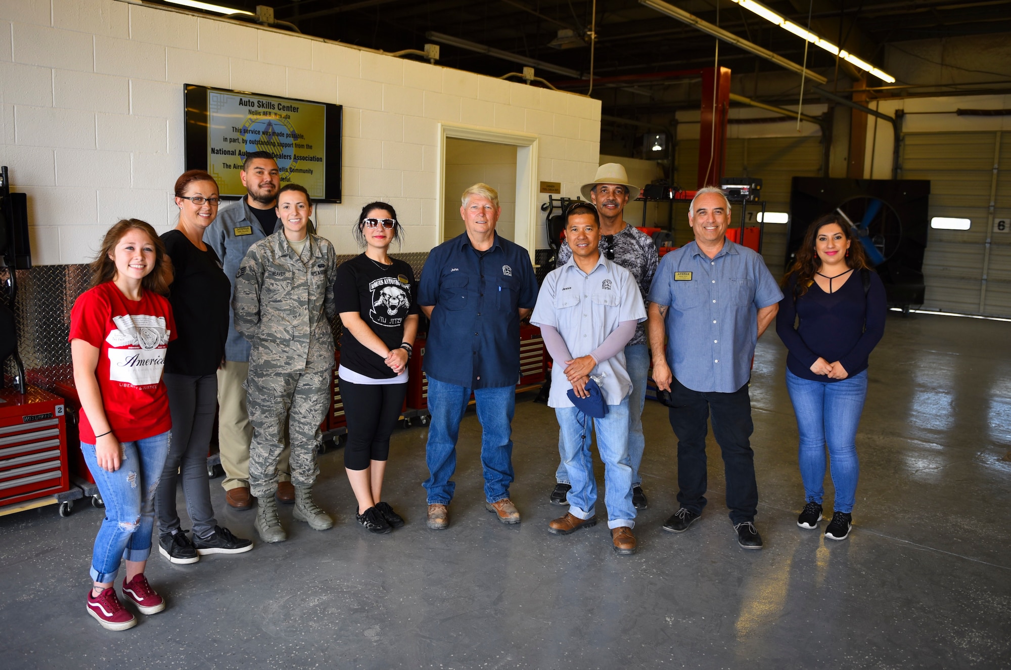Members of the 99th Force Support Squadron celebrate the grand re-opening of the Auto Hobby Shop at Nellis Air Force Base, Nevada, May 31, 2018. The shop underwent major renovations to repair the facility as well as supply customers with the proper tools to perform maintenance on their vehicles. (U.S. Air Force photo by Airman 1st Class Andrew D. Sarver)