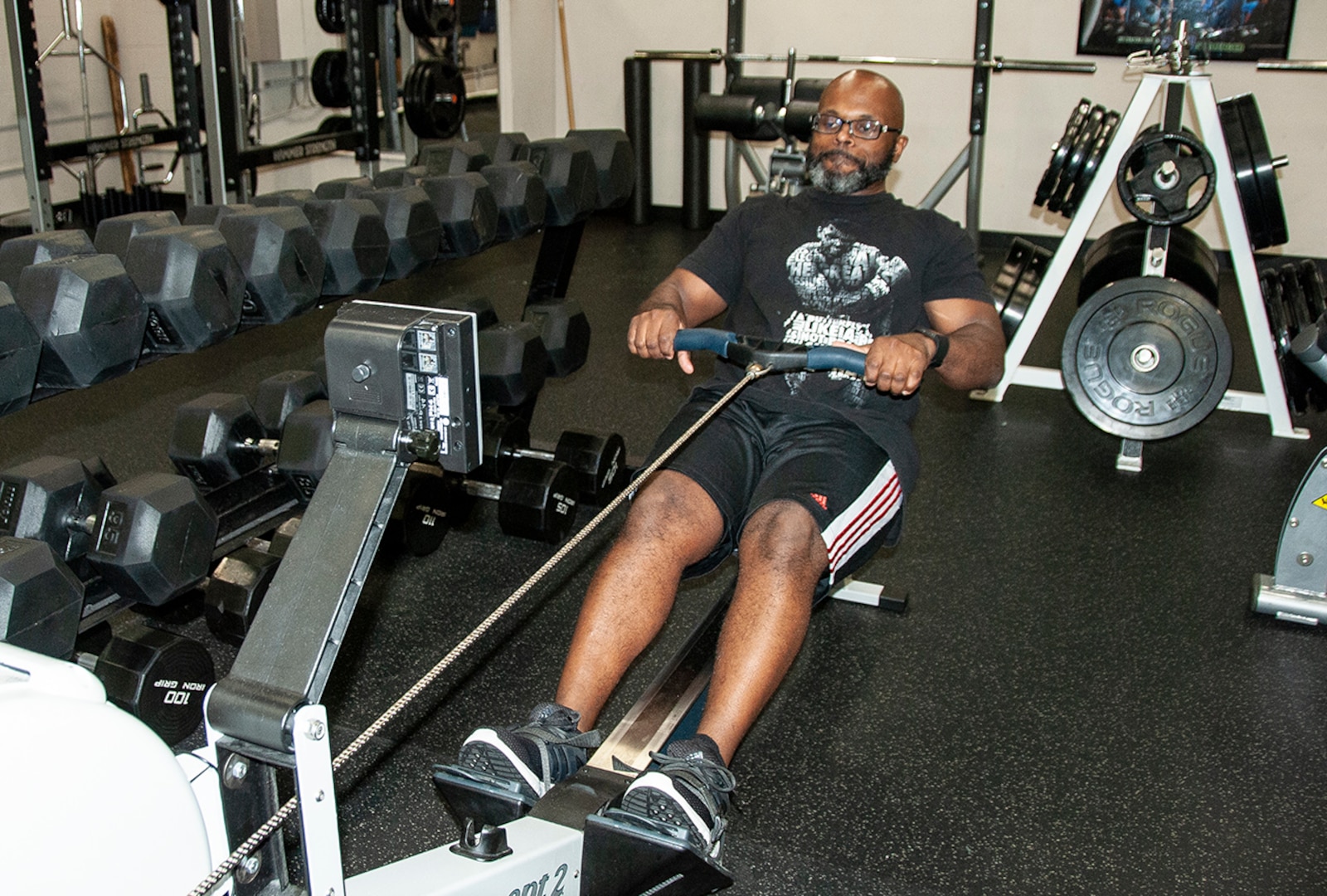 Tim Weatherspoon from DLA Energy relieves stress and improves his fitness on a rowing machine at the HQC Fitness Center. He took third place in the 500-meter and 1,000-meter rowing contest during the May Fitness Challenge May 14-17. Photo by Beth Reece