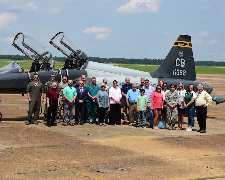 Members of the Pilot Partner Program and Team BLAZE members stand in front of a T-38C Talon during a base tour May 30, 2018, at Columbus Air Force Base, Mississippi. The Pilot Partner program pair local businesses with specialized undergraduate pilot training classes to help build base-community relations. (U.S. Air Force photo by Elizabeth Owens)