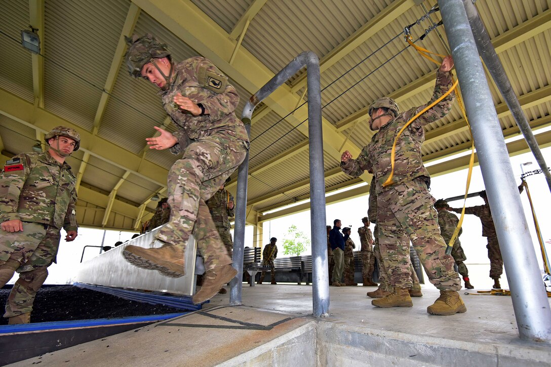 Soldiers conduct mock door exercises.