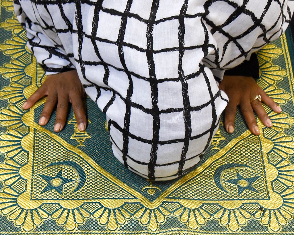 Chief Master Sgt. Gloria Weatherspoon, 379th Expeditionary Force Support Squadron superintendent, demonstrates the prayer performed during Ramadan May 13, 2018, at Al Udeid Air Base, Qatar. After returning to her home station after this deployment, Weatherspoon will submit an official request to wear a hijab in uniform. (U.S. Air Force photo by Staff Sgt. Enjoli Saunders)