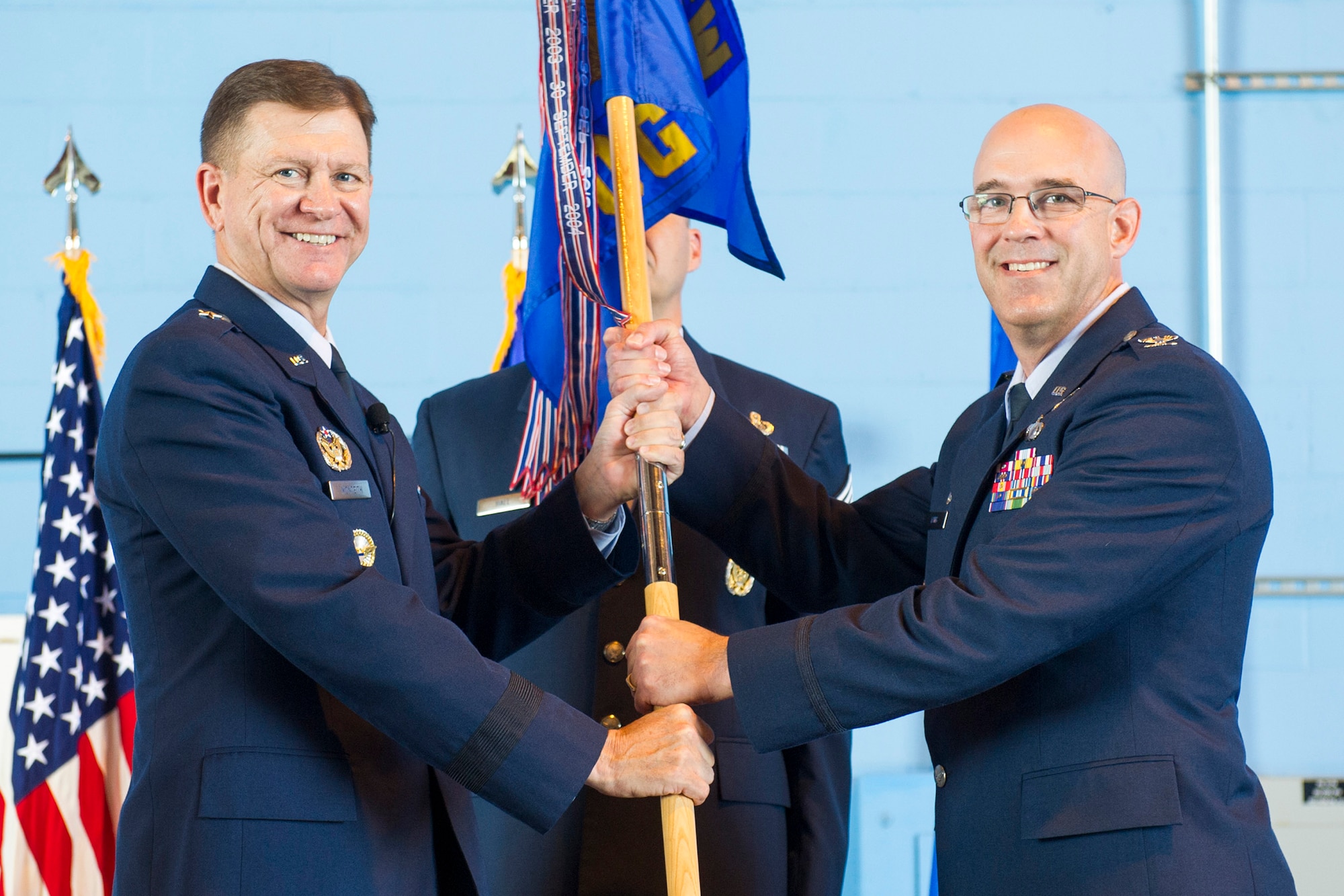 Brig. Gen. Wayne Monteith, commander of the 45th Space Wing presents Col. Steven Lang, commander of the 45th Launch Group and the 45th Operations Group with the 45th OG guidon, June 1, 2018 at Cape Canaveral Air Force Station, Fla. Lang assumed command from Col. Burton Catledge, and took on the role of the 45th LCG and the 45th OG commander. (U.S. Air Force photo by Phil Sunkel)