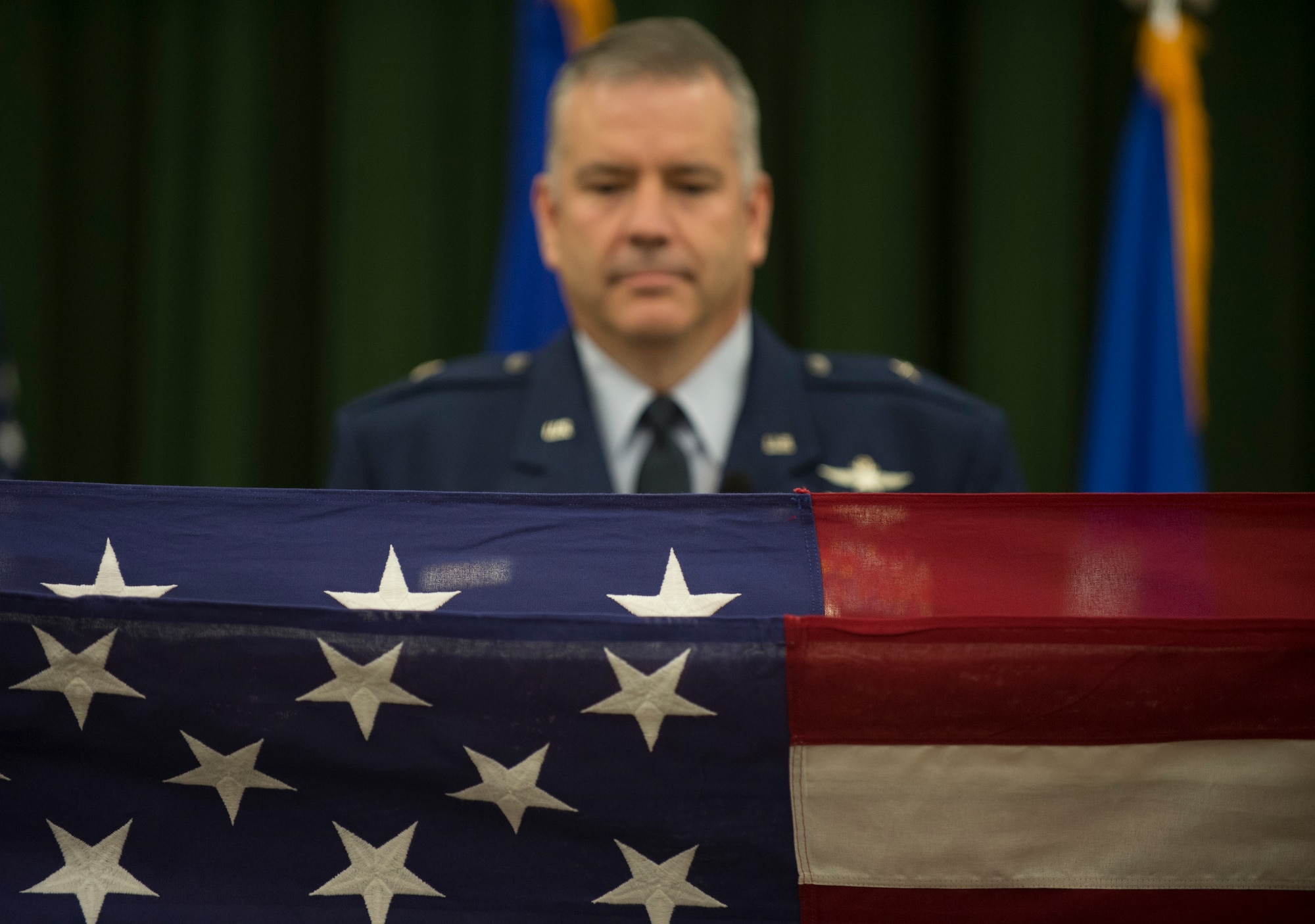 Brig. Gen. Mitchel Butikofer, Air Forces Cyber vice commander, stands at the position of attention as the U.S. flag is folded during his retirement ceremony at Joint Base San Antonio-Lackland, Texas, June 1, 2018. Butikofer retired after 29 years of service. (U.S. Air Force photo by Tech. Sgt. R.J. Biermann)