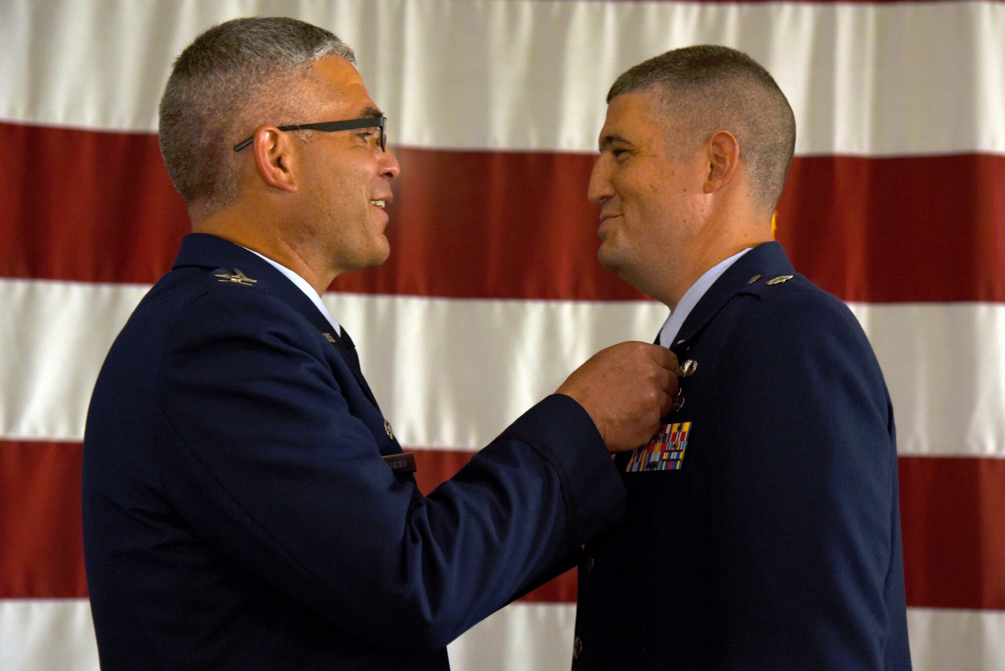 U.S. Air Force Col. Alex Ganster, 17th Training Group commander, pins the Meritorious Service Medal on Lt. Col. Kenneth Stremmel, 315th Training Squadron outgoing commander, during the 315th TRS Change of Command at the Louis F. Garland Department of Defense Fire Academy High Bay on Goodfellow Air Force Base, Texas, June 1, 2018. Stremmel was the 315th TRS commander for two years and helped develop intelligence, surveillance and reconnaissance warriors. (U.S. Air Force photo by Staff Sgt. Joshua Edwards/Released)