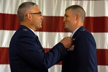 U.S. Air Force Col. Alex Ganster, 17th Training Group commander, pins the Meritorious Service Medal on Lt. Col. Kenneth Stremmel, 315th Training Squadron outgoing commander, during the 315th TRS Change of Command at the Louis F. Garland Department of Defense Fire Academy High Bay on Goodfellow Air Force Base, Texas, June 1, 2018. Stremmel was the 315th TRS commander for two years and helped develop intelligence, surveillance and reconnaissance warriors. (U.S. Air Force photo by Staff Sgt. Joshua Edwards/Released)