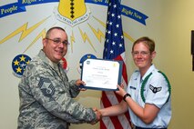 U.S. Air Force Chief Master Sgt. Daniel Stein, 17th Training Group superintendent, presents the 312th Training Squadron Student of the Month award to Airman 1st Class Cynthia Schroll, 312th TRS trainee, at Brandenburg Hall on Goodfellow Air Force Base, Texas, June 1, 2018. The 312th TRS’s mission is to provide Department of Defense and international customers with mission ready fire protection and special instruments graduates and provide mission support for the Air Force Technical Applications Center. (U.S. Air Force photo by Airman 1st Class Zachary Chapman/Released)