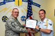 U.S. Air Force Chief Master Sgt. Daniel Stein, 17th Training Group superintendent, presents the 17th TRG Rope of the Month award to Airman 1st Class Dallin Wilson, 312th Training Squadron trainee, at Brandenburg Hall on Goodfellow Air Force Base, Texas, June 1, 2018. The 312th TRS’s mission is to provide Department of Defense and international customers with mission ready fire protection and special instruments graduates and provide mission support for the Air Force Technical Applications Center. (U.S. Air Force photo by Airman 1st Class Zachary Chapman/Released)