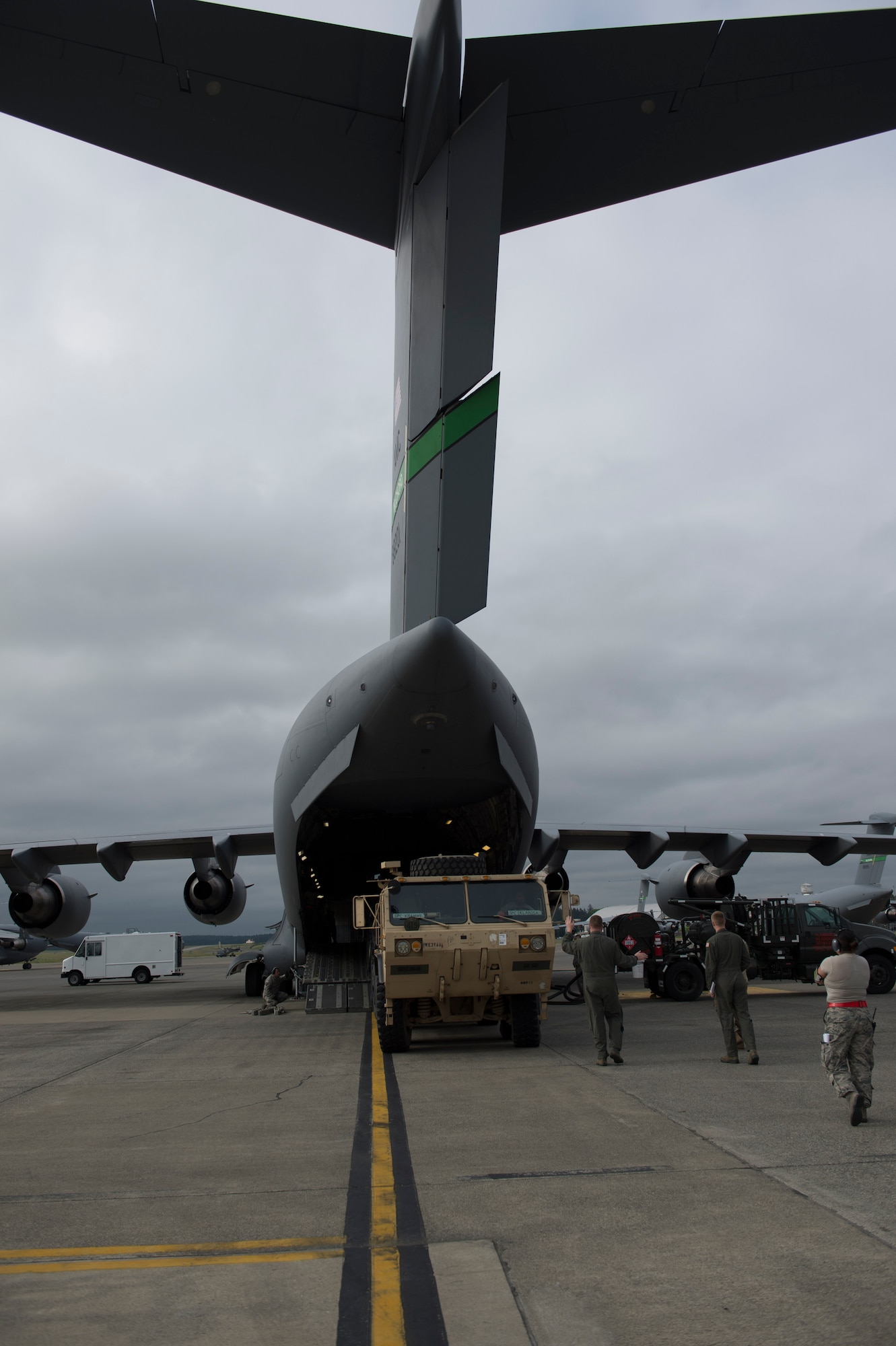 Tech Sgt. Brian Layton, 4th Airlift Squadron loadmaster, and members of the 62nd Aerial Port Squadron work with Army Soldiers to load an Army vehicle into a C-17 Globemaster III, May 21, 2018, at Joint Base Lewis-McChord, Wash. With a cargo compartment 88 feet long and 18 feet high, the C-17 can carry 170,900 pounds of cargo. (U.S. Air Force photo by A1C Sara Hoerichs)