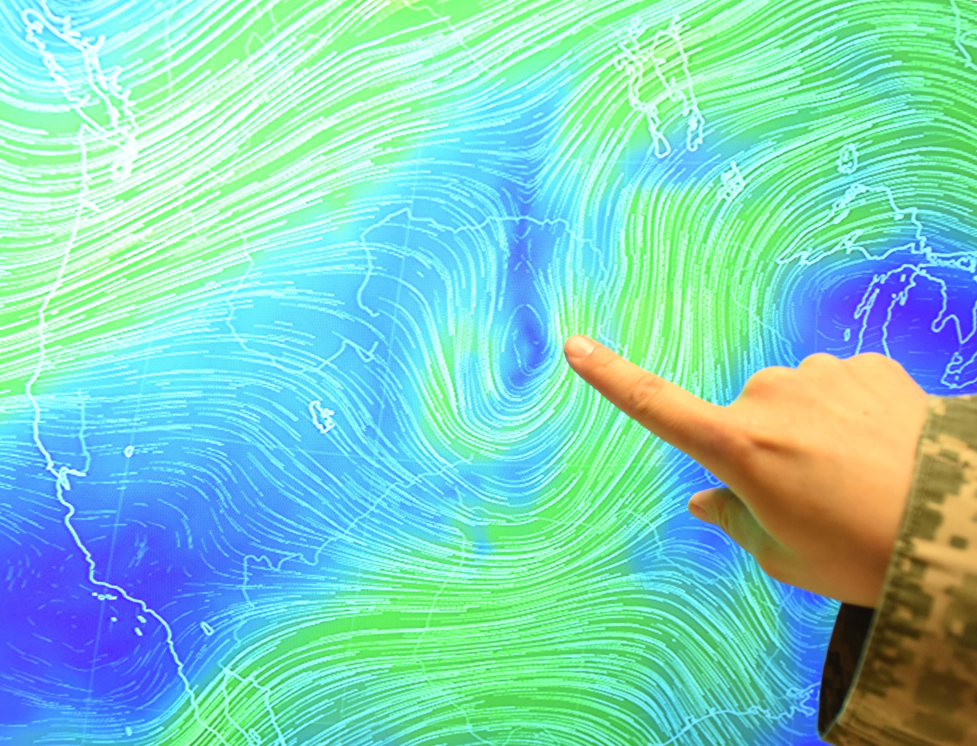 Master Sgt. Jessica Leiker, the 28th Operations Support Squadron noncommissioned officer in charge of mission weather operations, points at a low pressure zone over the Black Hills at Ellsworth Air Force Base, S.D., May 29, 2018. The Black Hills have some of the most unpredictable weather in the country and the weather flight is responsible for ensuring Airmen and aircraft are safe during all-weather conditions. (U.S. Air Force photo by Airman 1st Class Thomas Karol)