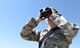Airman James Leos, 28th Operations Support Squadron weather apprentice, uses a pair of binoculars with a laser range finder to help forecast weather conditions at Ellsworth Air Force Base, S.D, May 30, 2018. The weather flight has to stay on the lookout for changing weather conditions so the flying mission is not affected by any surprise changes in the weather. (U.S. Air Force photo by Airman 1st Class Thomas Karol)