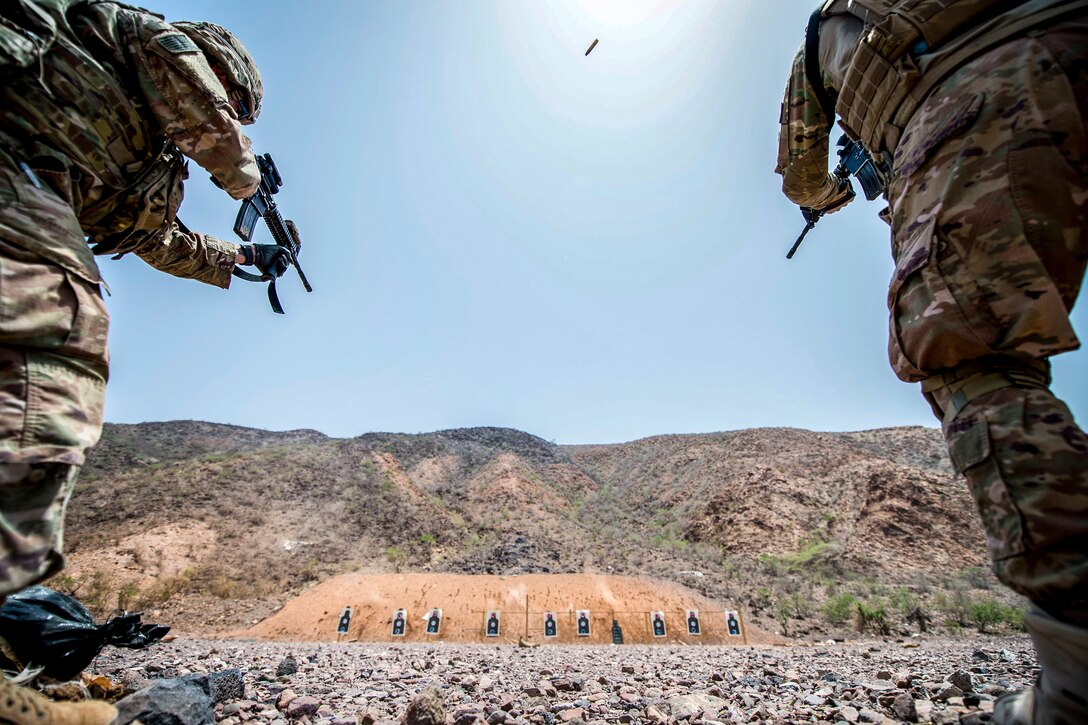 Two soldiers fire on either side of the photo frame fire at targets between them.