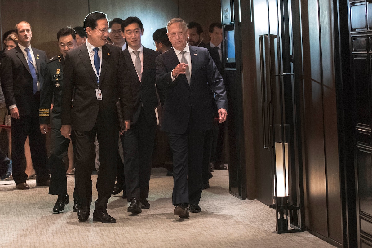 Defense Secretary James N. Mattis walks with South Korean Minister of Defense Song Young-moo.