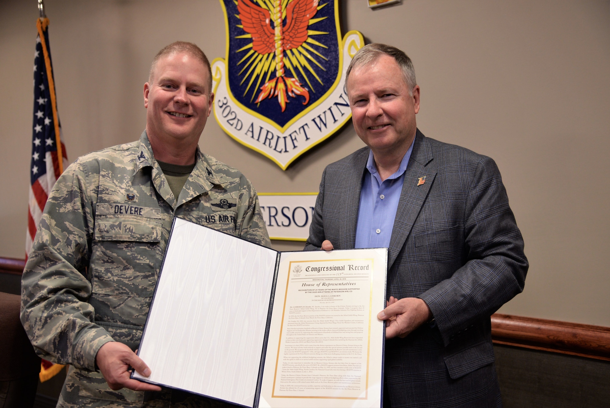 U.S. Rep. Doug Lamborn, presents a copy of the Congressional Record recognizing the Air Force Reserve’s 302nd Airlift Wing for its 25 years supporting the Modular Airborne Fire Fighting System mission to Col. James DeVere, the 302nd AW commander, at Peterson Air Force Base, Colorado, June 1, 2018. Lamborn came to the wing on an official visit to discuss the MAFFS mission with DeVere. Lamborn’s proclamation was officially added to the U.S. House of Representatives Congressional Record April 26, 2018. (U.S. Air Force photo/Staff Sgt. Frank Casciotta)