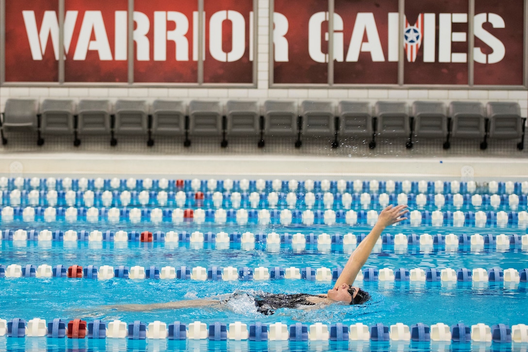 A Marine trains in the backstroke during swimming practice.