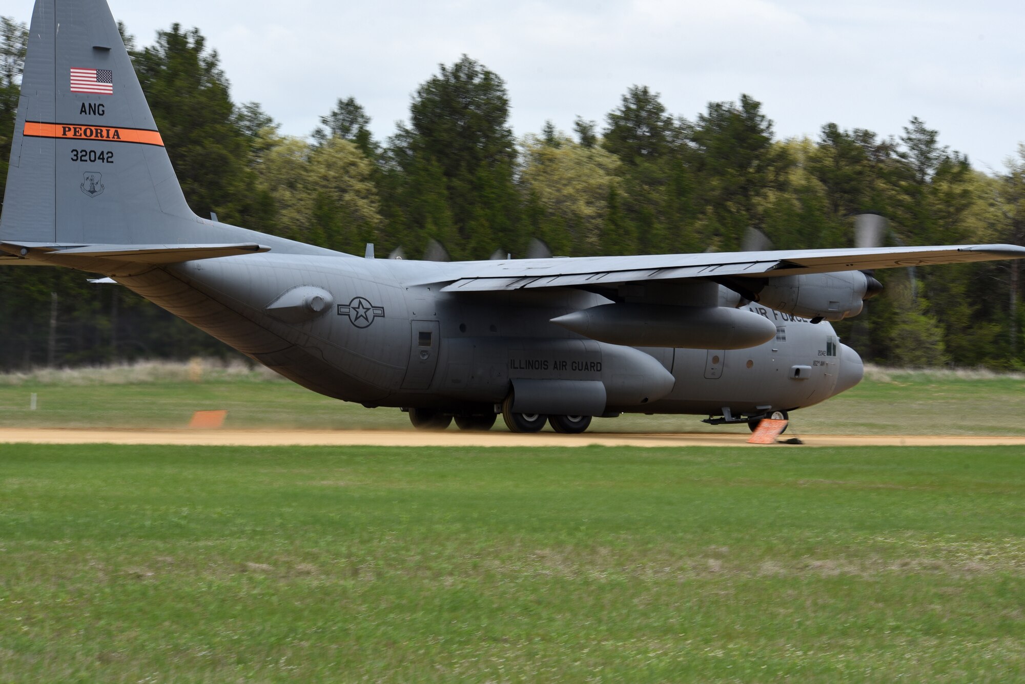 A C-130 Hercules from the 182nd Airlift Wing, Illinois Air National Guard, lands in the touchdown zone at Young Landing Zone at Fort McCoy, Wis. May 14, 2018. A number of pilots were qualifying to complete their unimproved landing certification. (U.S. Air National Guard photo by Master Sgt. Todd A. Pendleton)