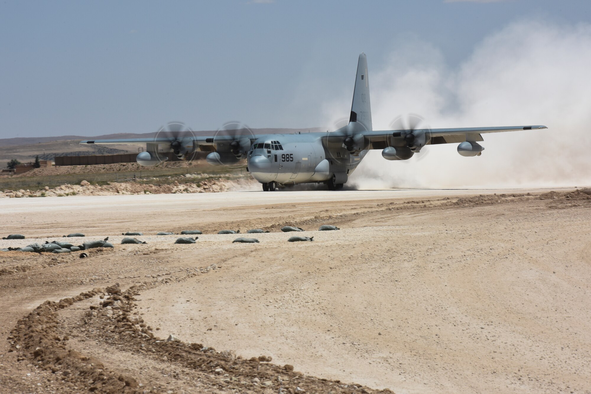 A U.S. Marine Corps KC-130J Hercules lands on a runway at an undisclosed location, May 18, 2018. C-130 aircraft are used for transporting personnel and cargo in the area of responsibility. (U.S. Air Force photo by Tech. Sgt. Caleb Pierce)