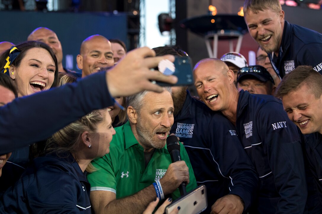 Movie and television personality Jon Stewart takes selfies with Team Navy.