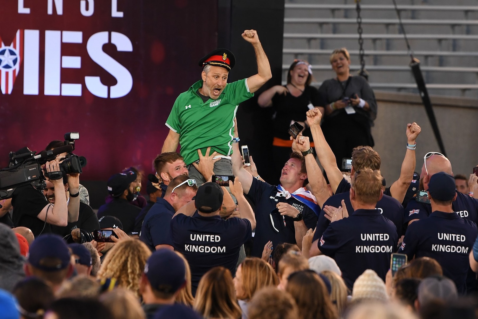 Movie and television personality Jon Stewart gets a lift by Team United Kingdom while hosting opening ceremonies for the 2018 Warrior Games at the U.S. Air Force Academy in Colorado Springs, Colo., June 2, 2018. DoD photo by EJ Hersom