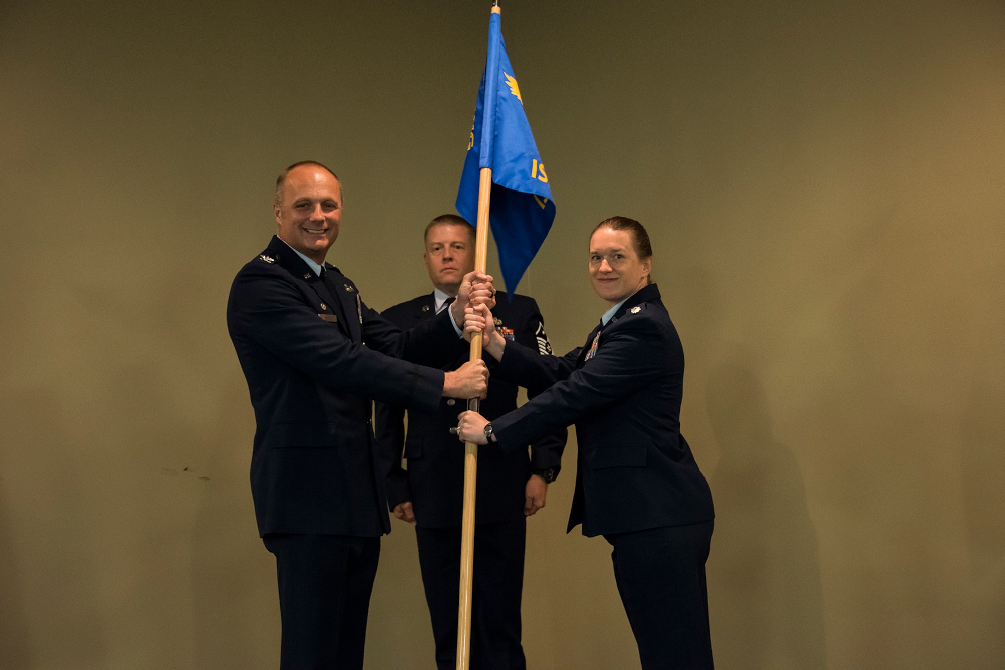 Col. Robert I. Kinney, 188th Wing commander, passes the 188th Intelligence, Surveillance, and Reconnaissance Group's guidon to Lt. Col. Sara A Stigler during an Assumption of Command ceremony held June 2, 2018 at Ebbing Air National Guard Base, Arkansas. Stigler, a career intelligence officer, assumed command of the 188th ISR Group. (U.S. Air National Guard photo by Tech. Sgt. John E. Hillier)