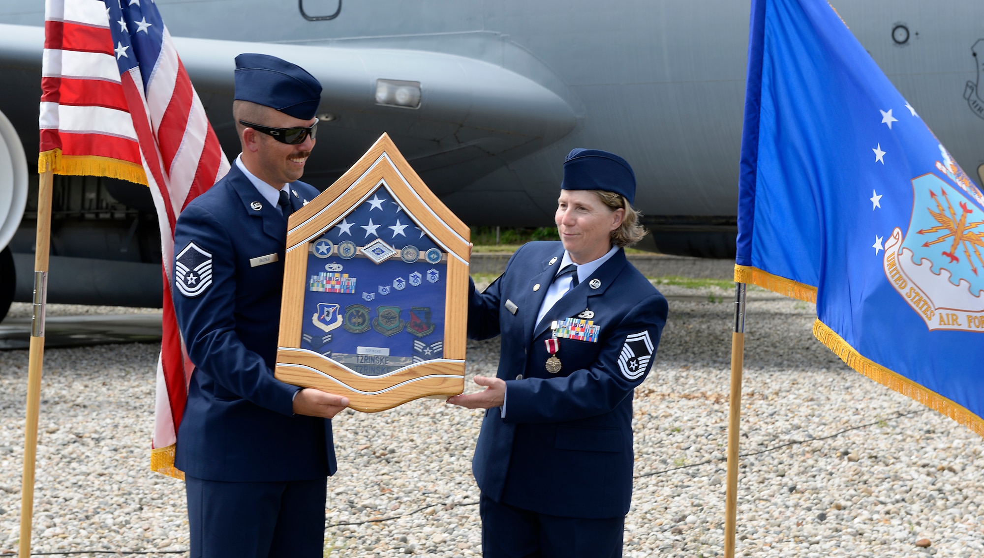 Senior Master Sgt. Deborah A Tzrinske receives her shadow box from Master Sgt. Kevin C. Reiter, the 157th Air Refueling Wing administration superintendent, during her retirement ceremony on June 2, 2018 at Pease Air National Guard Base, N.H. Tzrinske served as the 157th ARW first sergeant for more than eight years and retired after more than 28 years of service. (N.H. Air National Guard photo by Staff Sgt. Kayla White)