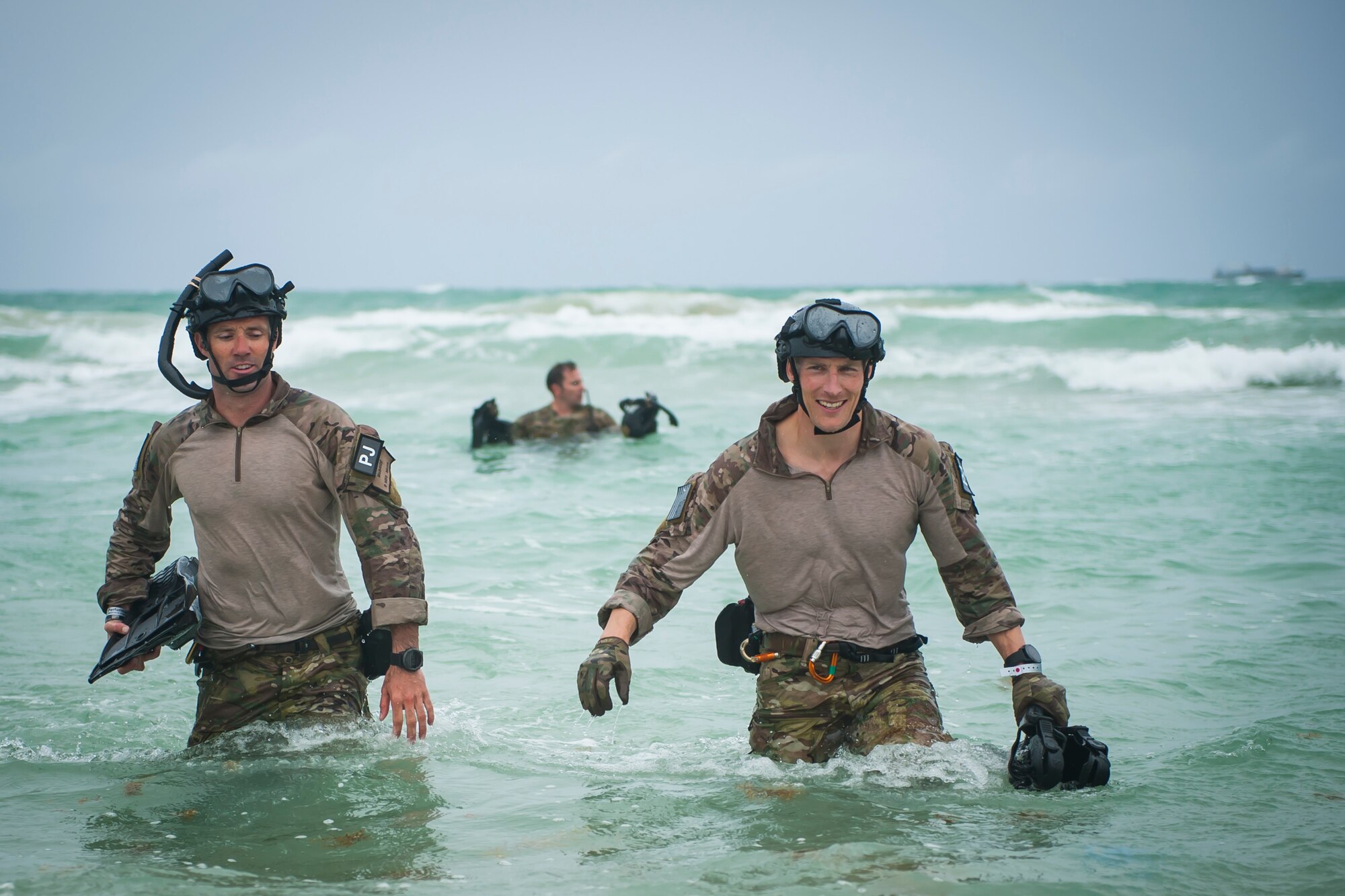 Air Force Reserve pararescuemen from the 920th Rescue Wing walk ashore after jumping out of a helicopter on May 26th, 2018 during the 2nd annual Salute to American Heroes Air and Sea Show, in Miami Beach. This two-day event showcases military fighter jets and other aircraft and equipment from all branches of the United States military in observance of Memorial Day, honoring servicemembers who have made the ultimate sacrifice. (U.S. Air Force photo/Staff Sgt. Jared Trimarchi)