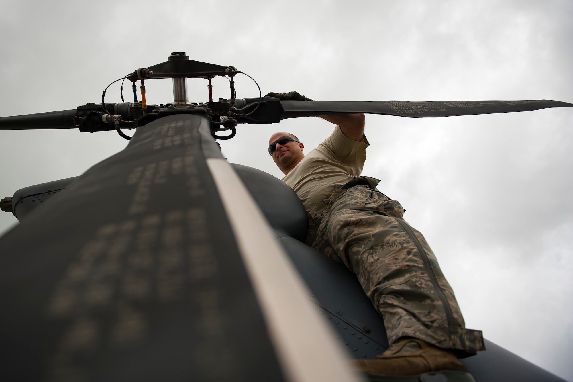 Tech. Sgt. Nicholas Barbieri, an Air Force Reserve Citizen Airmen from the 920th Rescue Wing out of Patrick Air Force Base in Cocoa Beach, Florida, inspects an HH-60G Pave Hawk helicopter on May 27th, 2018 during the 2nd annual Salute to American Heroes Air and Sea Show, in Miami. This two-day event showcases military fighter jets and other aircraft and equipment from all branches of the United States military in observance of Memorial Day, honoring servicemembers who have made the ultimate sacrifice. (U.S. Air Force photo/Staff Sgt. Jared Trimarchi)