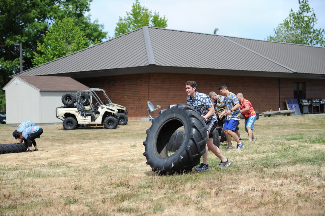 U.S. Airmen with the 446th Aeromedical Evacuation Squadron move tires as part of the first ever 446th AES amazing race morale event, June 2, 2018 at Joint Base Lewis-McChord Wash. (U.S. Air Force photo by Master Sgt. Minnette Mason)