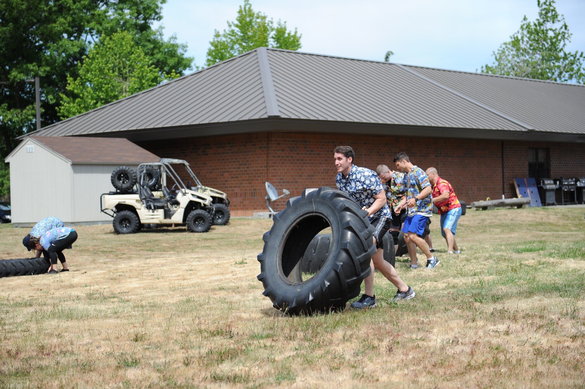 U.S. Airmen with the 446th Aeromedical Evacuation Squadron move tires as part of the first ever 446th AES amazing race morale event, June 2, 2018 at Joint Base Lewis-McChord Wash. (U.S. Air Force photo by Master Sgt. Minnette Mason)