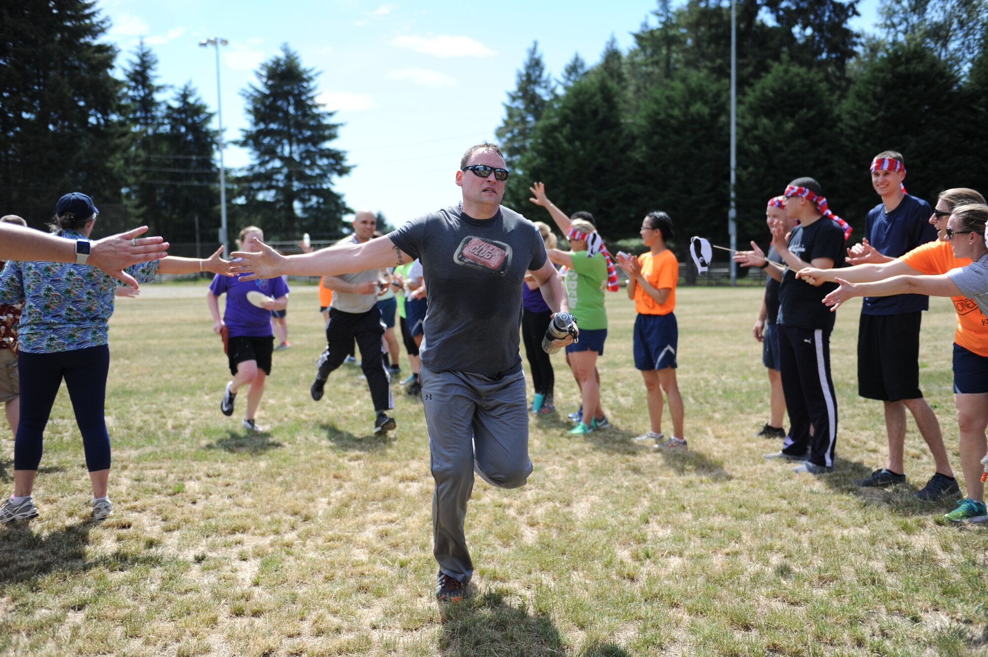 U.S. Airmen with the 446th Aeromedical Evacuation Squadron cheer as AES Citizen Airmen complete the first ever 446th AES amazing race morale event, June 2, 2018 at Joint Base Lewis-McChord Wash. (U.S. Air Force photo by Master Sgt. Minnette Mason)