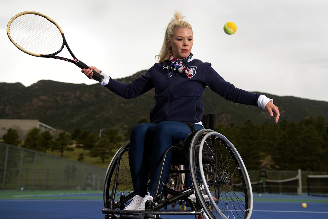 Nikky Williams takes a lesson in wheelchair tennis during an exposition day for the 2018 DoD Warrior Games