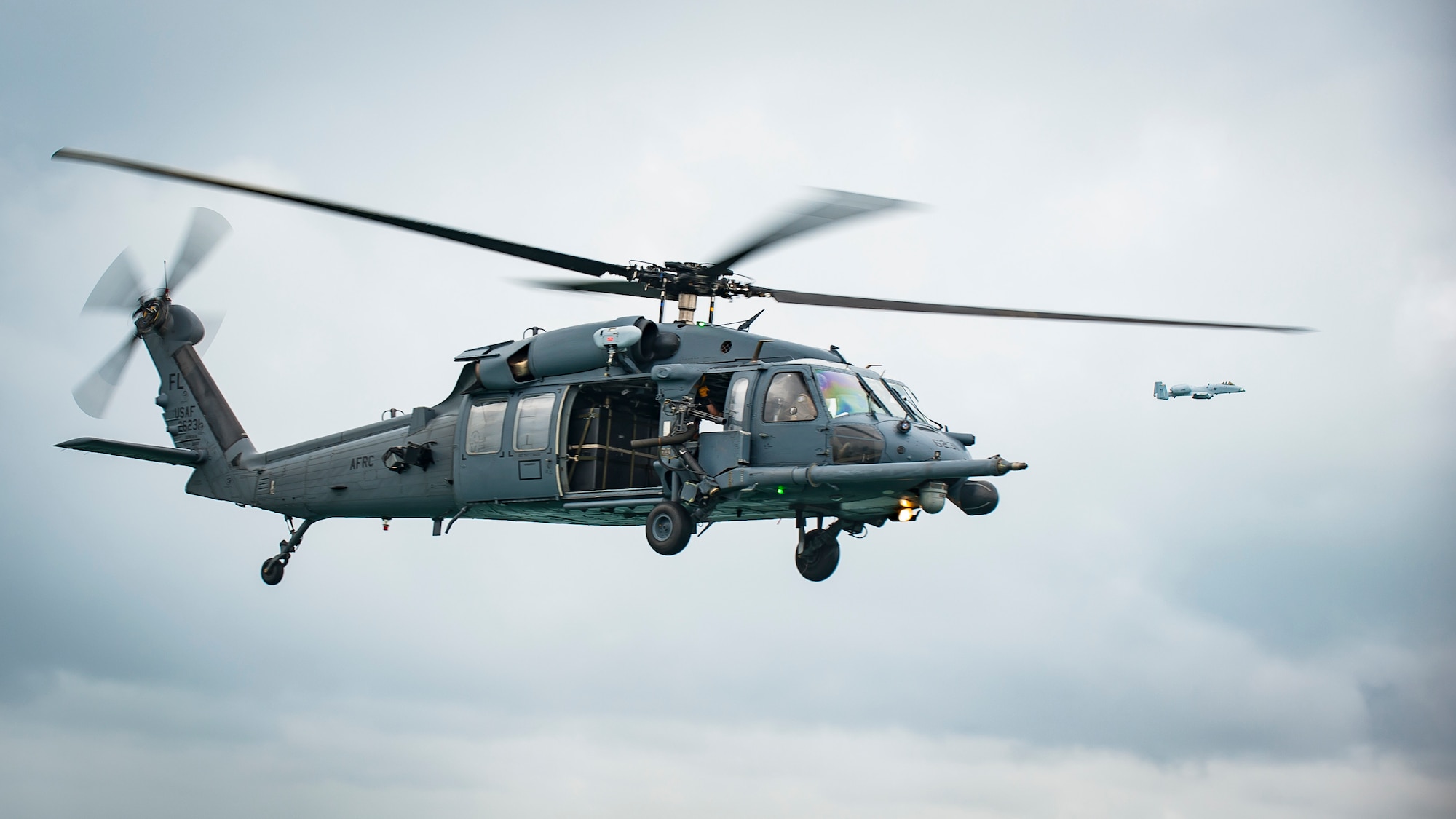 Air Force Reserve Citizen Airmen from the 301st Rescue Squadron out of Patrick Air Force Base in Cocoa Beach, Florida, fly with an  A-10 Thunderbolt II pilot, aboard an HH-60G Pave Hawk helicopter on May 25th, 2018 during a practice run for the 2nd annual Salute to American Heroes Air and Sea Show over Miami Beach, Florida. This two-day event showcases military fighter jets and other aircraft and equipment from all branches of the United States military in observance of Memorial , servicemembers who have made the ultimate sacrifice. (U.S. Air Force photo/Staff Sgt. Jared Trimarchi)