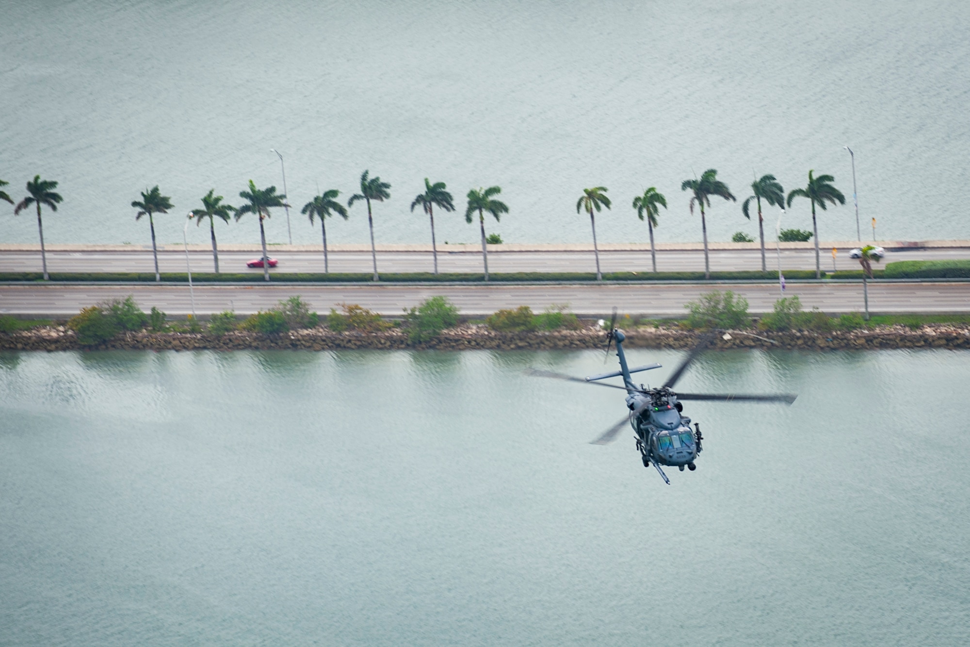 Air Force Reserve Citizen Airmen from the 301st Rescue Squadron out of Patrick Air Force Base in Cocoa Beach, Florida fly near Miami Beach aboard an HH-60G Pave Hawk helicopter on May 25th, 2018 during a practice run for the 2nd annual Salute to American Heroes Air and Sea Show. This two-day event showcases military fighter jets and other aircraft and equipment from all branches of the United States military in observance of Memorial Day, honoring servicemembers who have made the ultimate sacrifice. (U.S. Air Force photo/Staff Sgt. Jared Trimarchi)