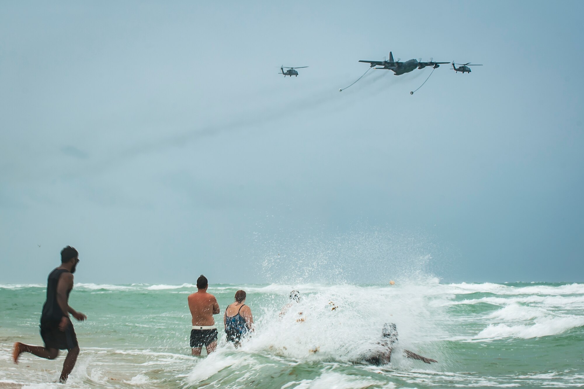 Crowds watch a demonstration of an HC-130- P/N “King” aircraft refuling two HH-60G Pave Hawk helicopters at Miami Beach on May 26th, 2018, during the 2nd annual Salute to American Heroes Air and Sea Show. This two-day event showcases military fighter jets and other aircraft and equipment from all branches of the United States military in observance of Memorial Day, honoring servicemembers who have made the ultimate sacrifice. (U.S. Air Force photo/Staff Sgt. Jared Trimarchi)