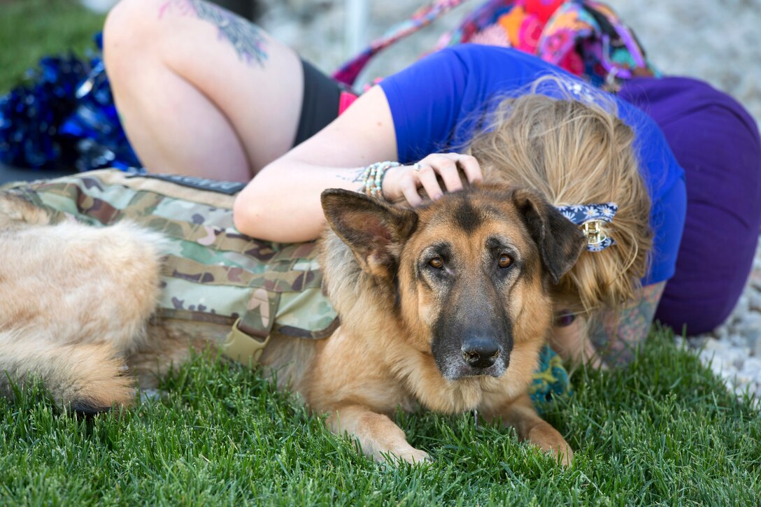An athlete takes a nap with her service dog.