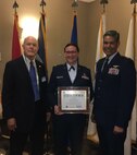U.S. Air Force Col. Raymundo Luevanos, 446th Mission Support Group Commander, accepts the ESGR Seven Seals Award on behalf of the 446th Airlift Wing from ESGR State Chairman John Patterson alongside U.S. Air Force Maj. Brooke Davis, 446th AW Chief of Public Affairs, May 5, 2018 at Tacoma Wash. (Courtesy photo).