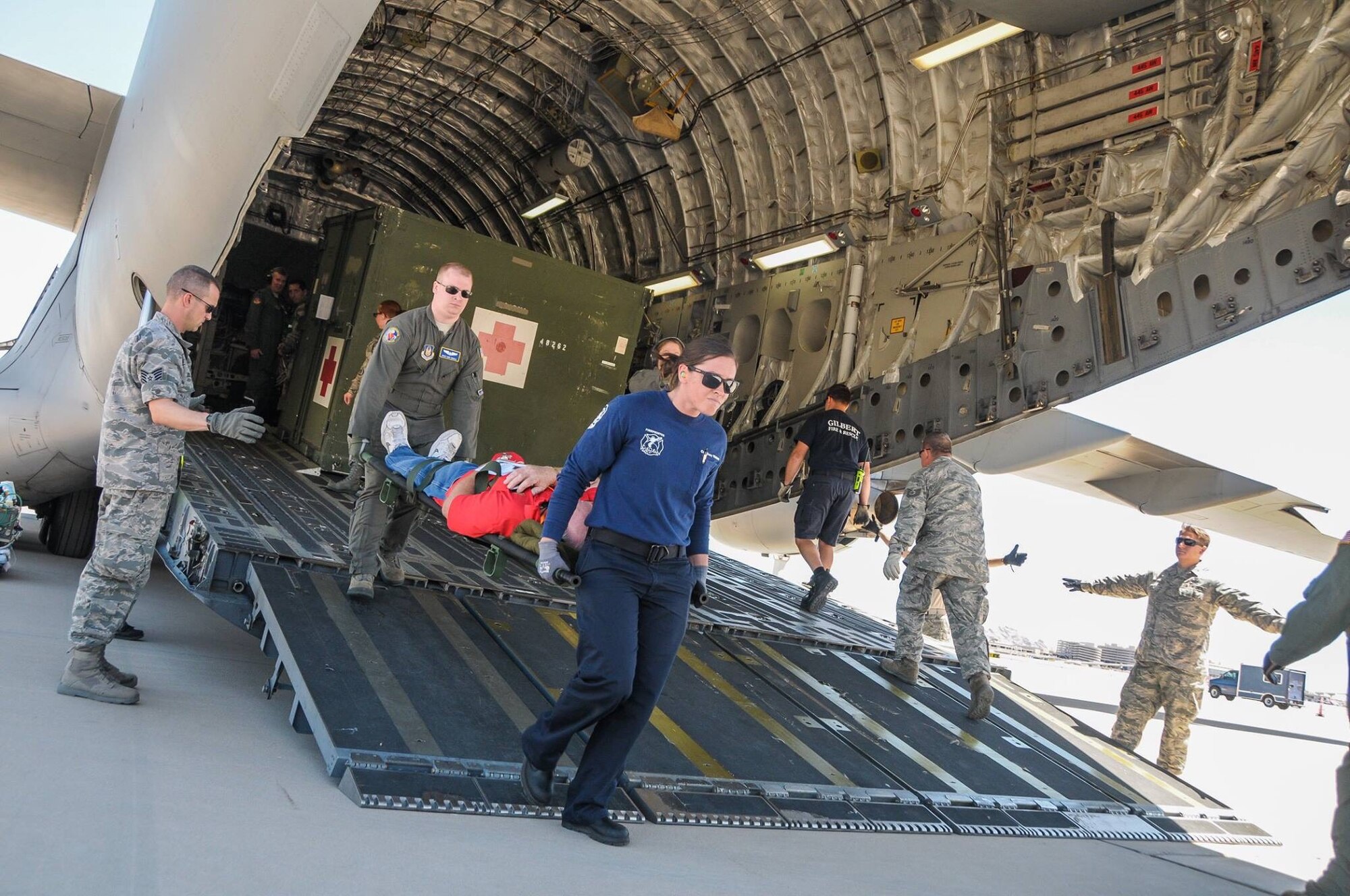 Reserve Citizen Airmen from Luke Air Force Base and Wright Patterson AFB work with local firefighters in transporting simulated patients during a National Disaster Mass Casualty exercise at the 161st Air Refueling Wing at Phoenix Sky Harbor.