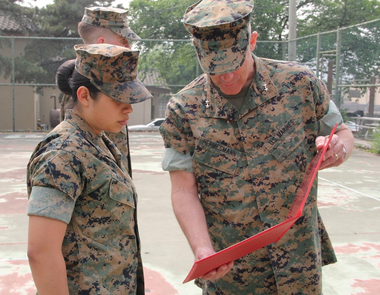 Sgt. Norma Azgomez (left), U.S. Marine Corps Forces Korea G1 non-commissioned officer in charge, is presented a Certificate of Commendation by Maj. Gen. Patrick J. Hermesmann, MARFORK commander, during a ceremony here, May 14. Azgomez was selected NCO of the Quarter for performing above her peers. (U.S. Marine Corps photo by Staff Sgt. Anthony Kirby/Released)