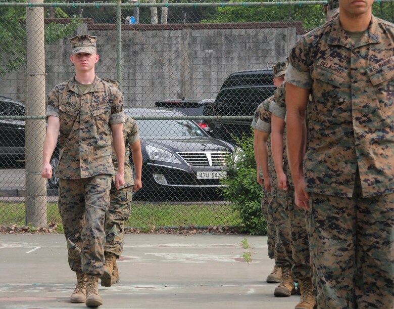 Lance Cpl. Marcus A. Whited, U.S. Marine Corps Forces Korea G6 help-desk clerk, marches to the front of a formation during a ceremony here, May 14. Whited was presented a Certificate of Commendation for being selected Marine of the Quarter. (U.S. Marine Corps photo by Staff Sgt. Anthony Kirby/Released)
